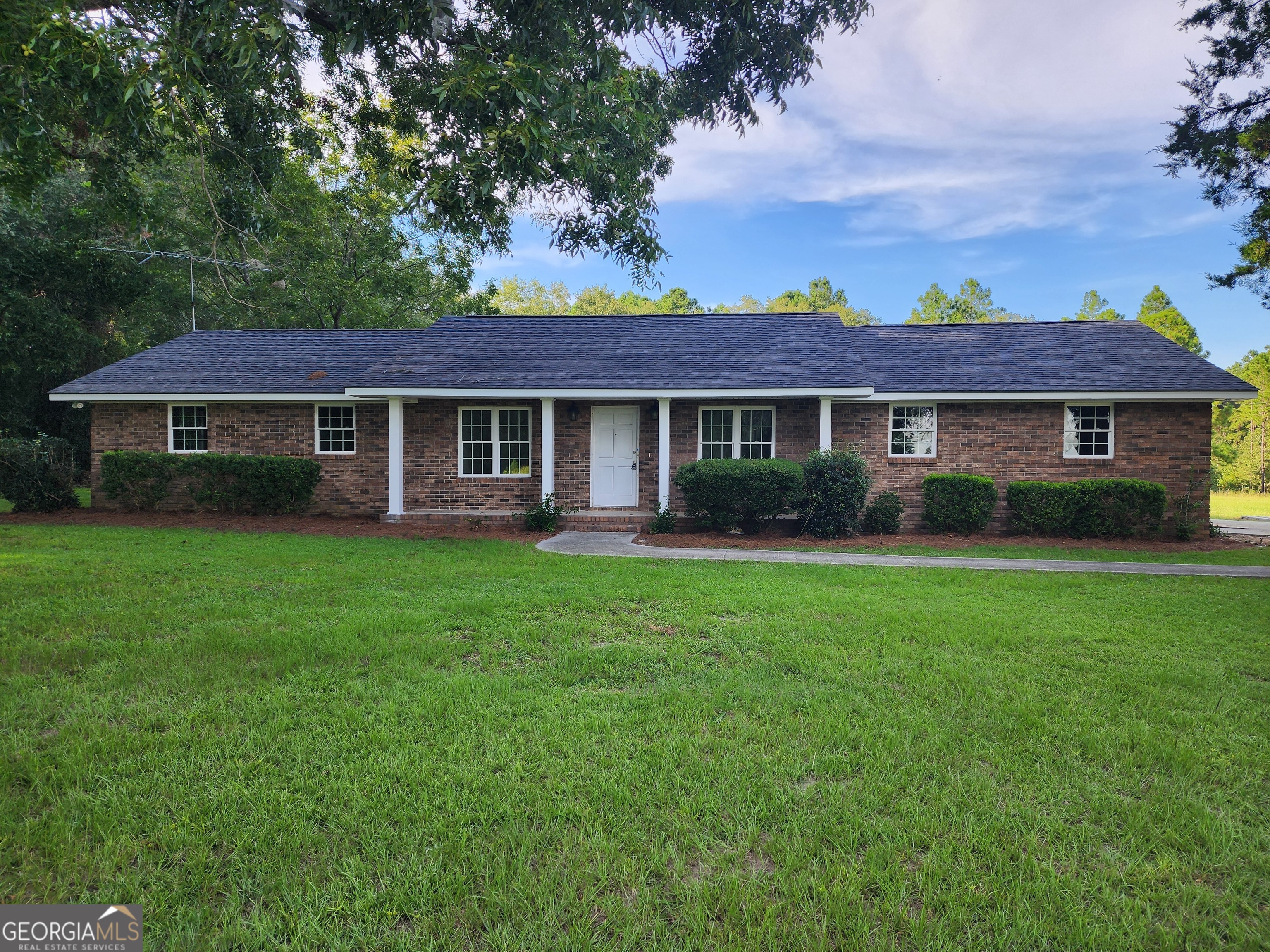 a front view of a house with a garden