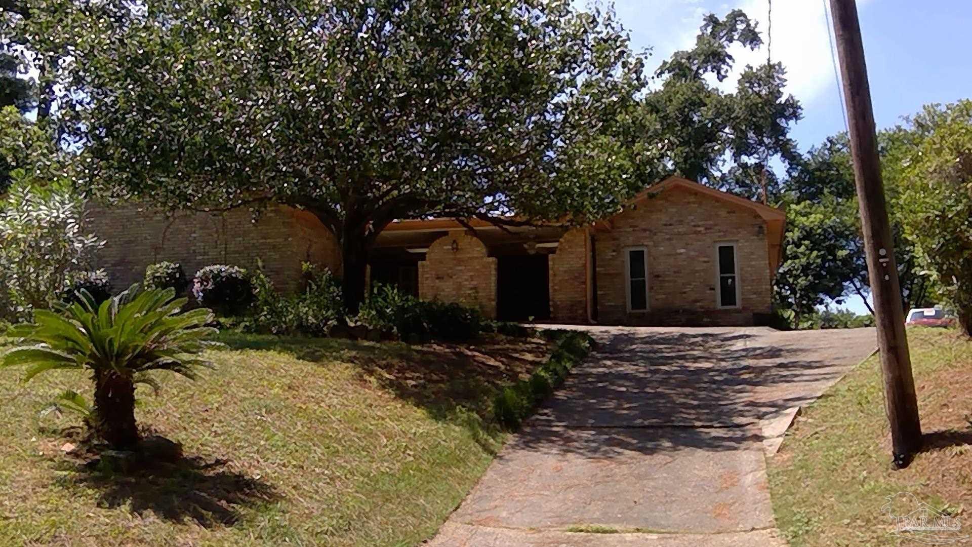 a view of a house with a tree in the yard