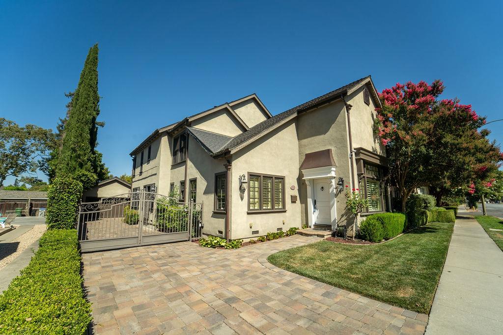 a front view of a house with a yard and potted plants