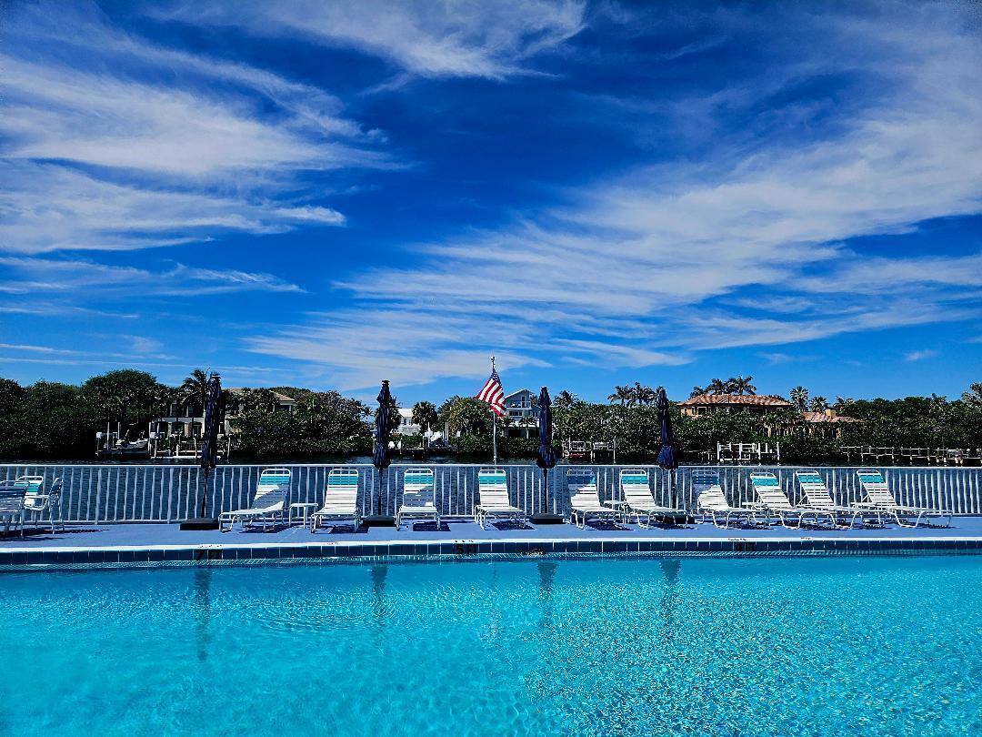 a view of a swimming pool and an outdoor seating