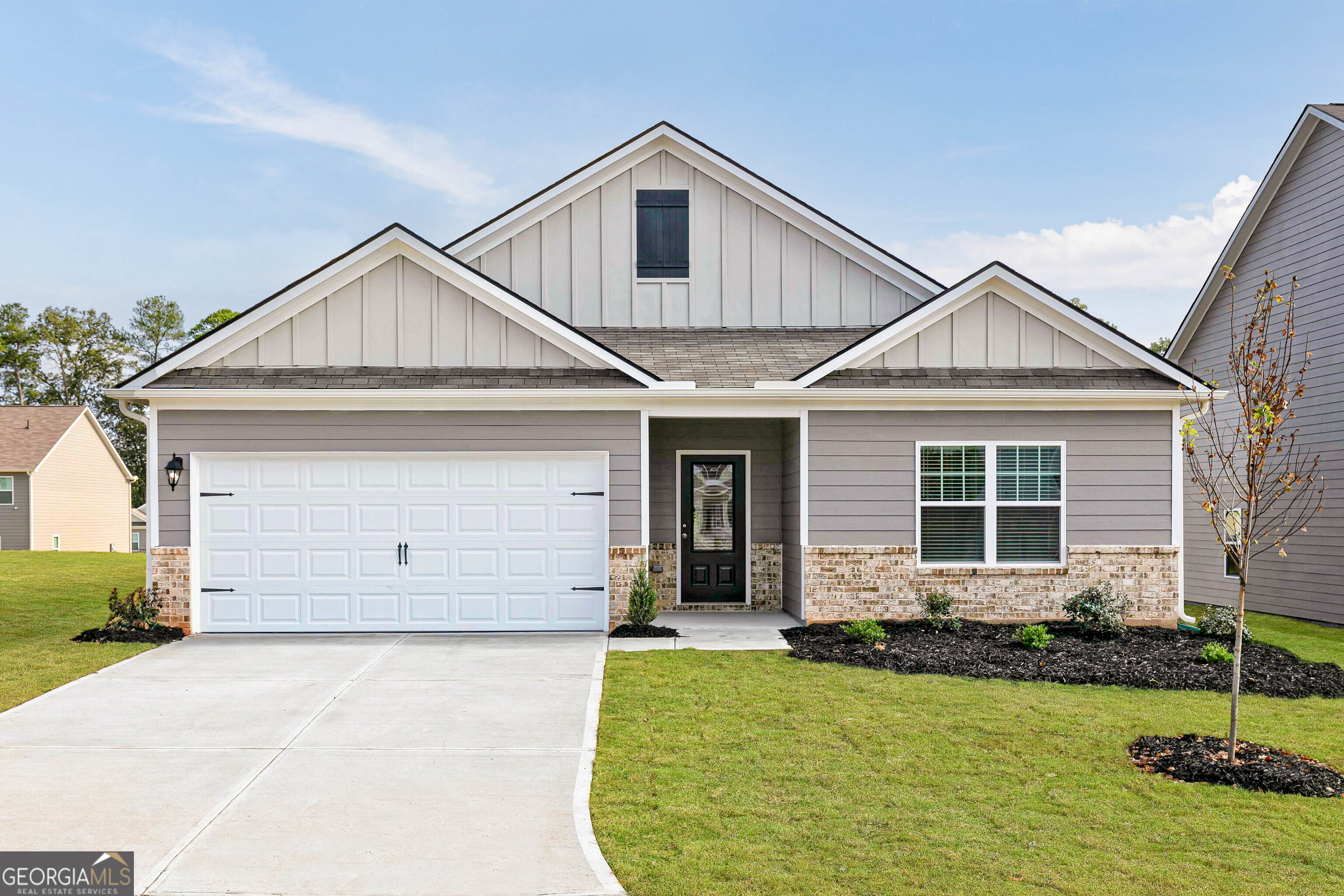 a front view of a house with a yard and garage