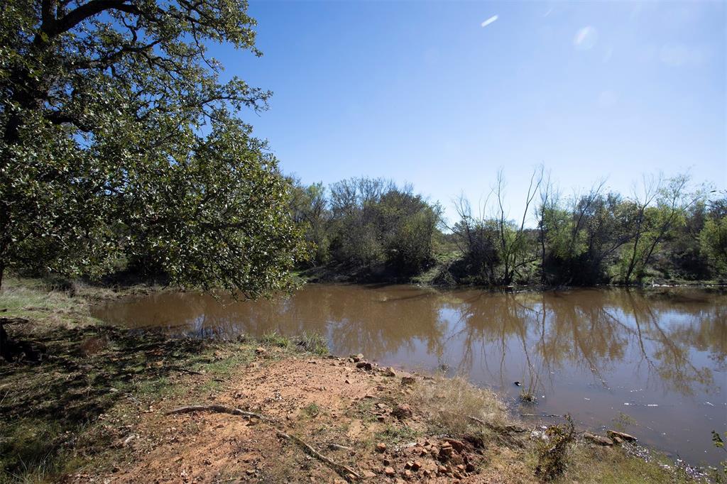 a view of a lake with trees in the background