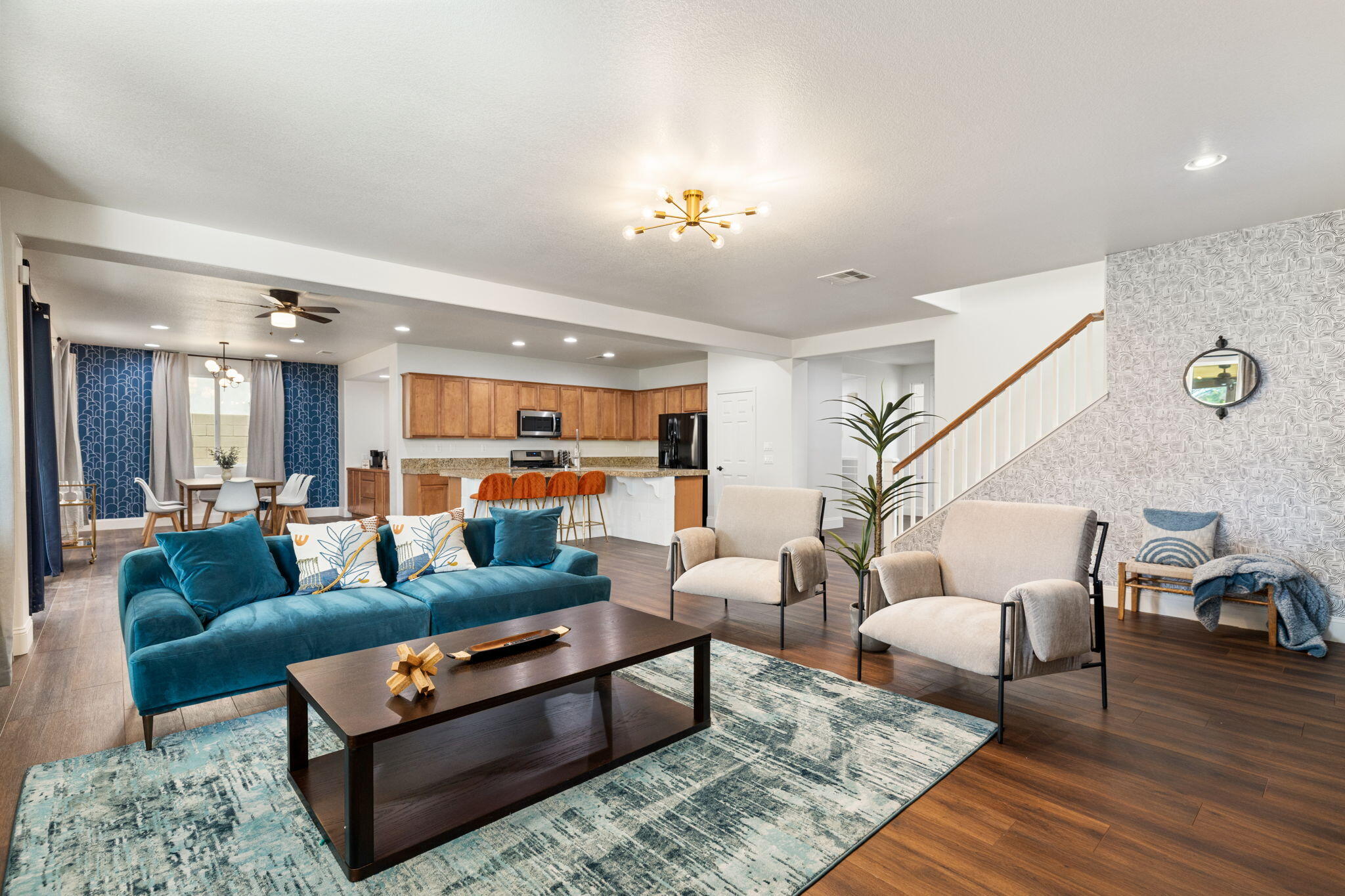 a living room with furniture and wooden floor