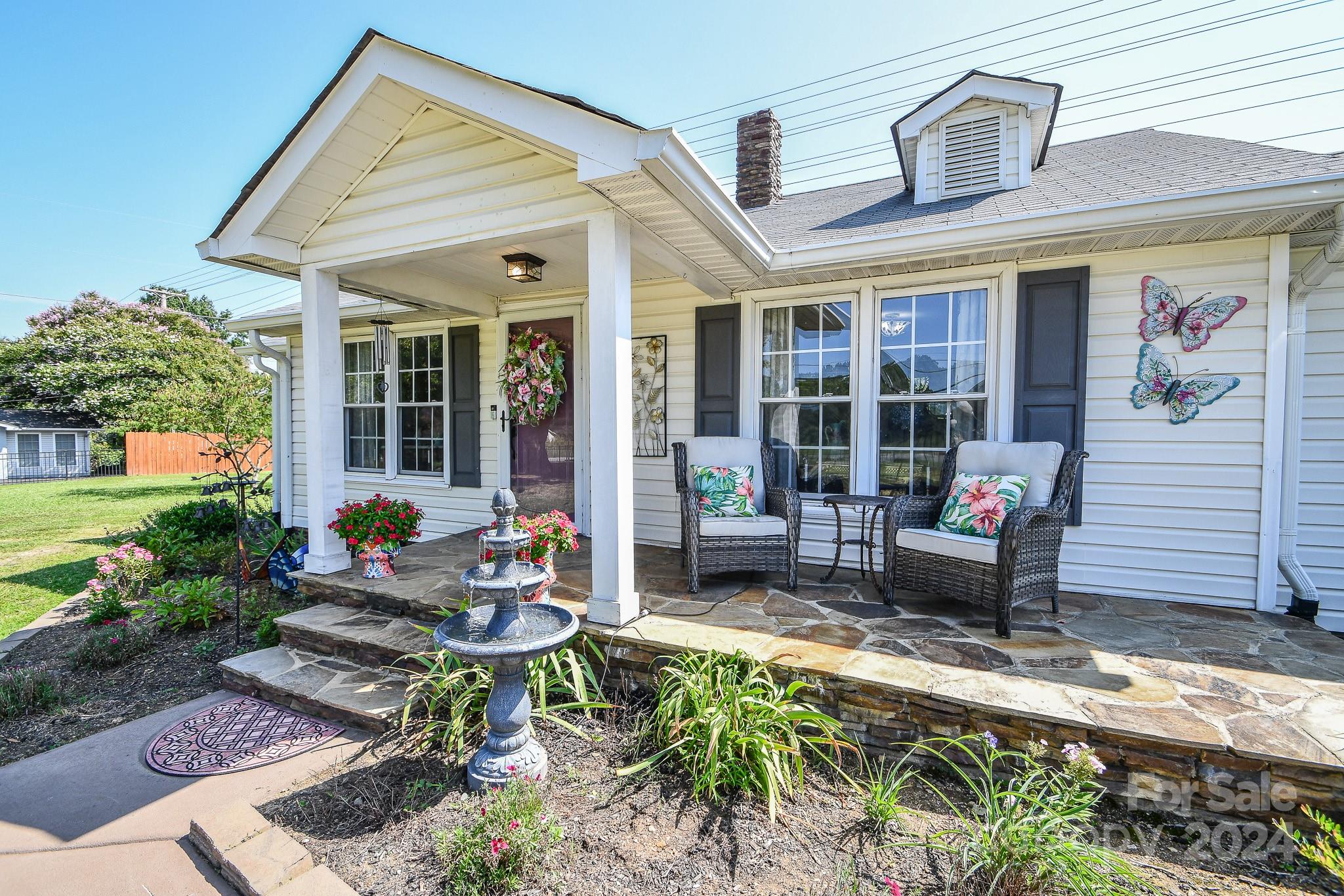 a backyard of a house with outdoor seating