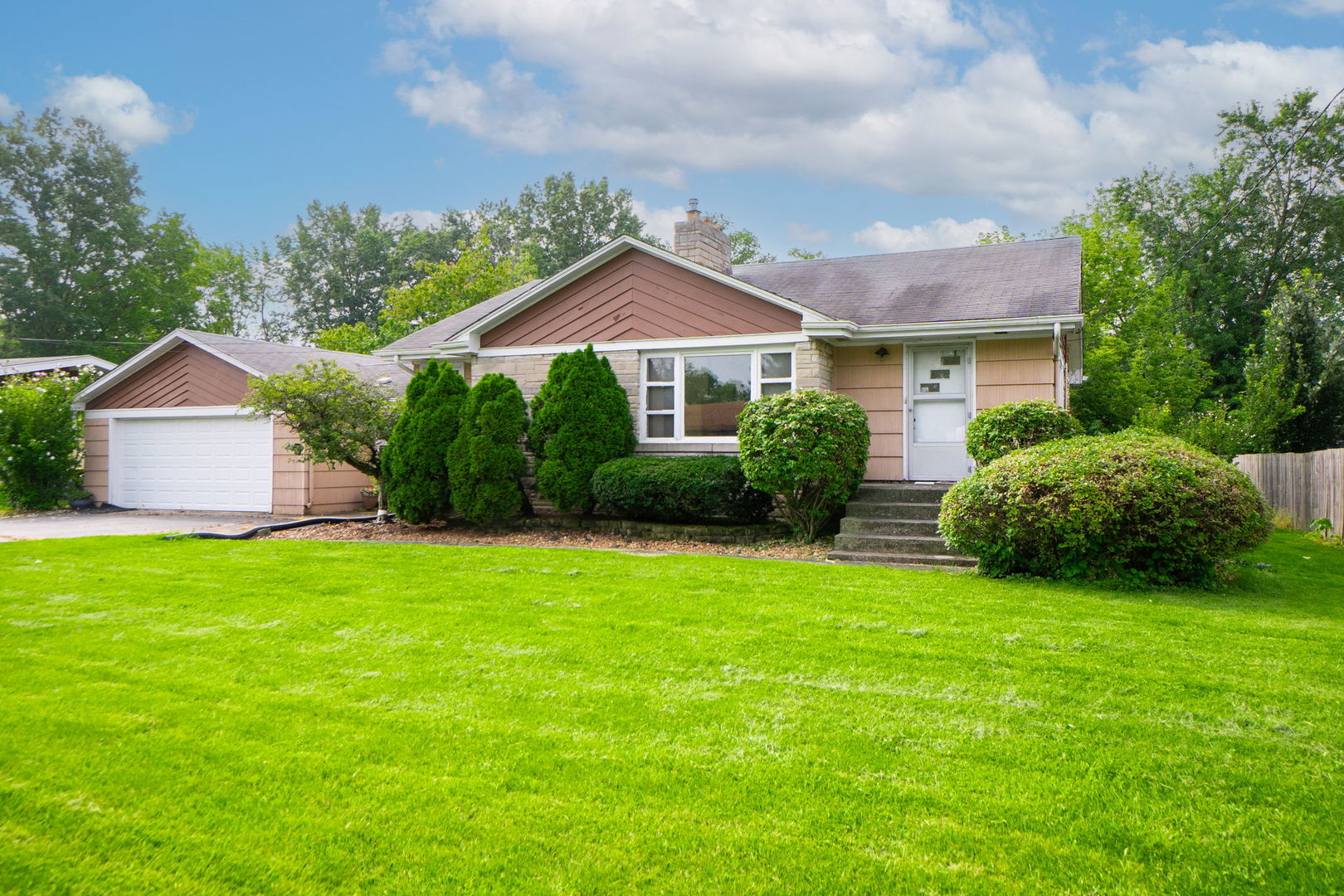 a front view of a house with garden