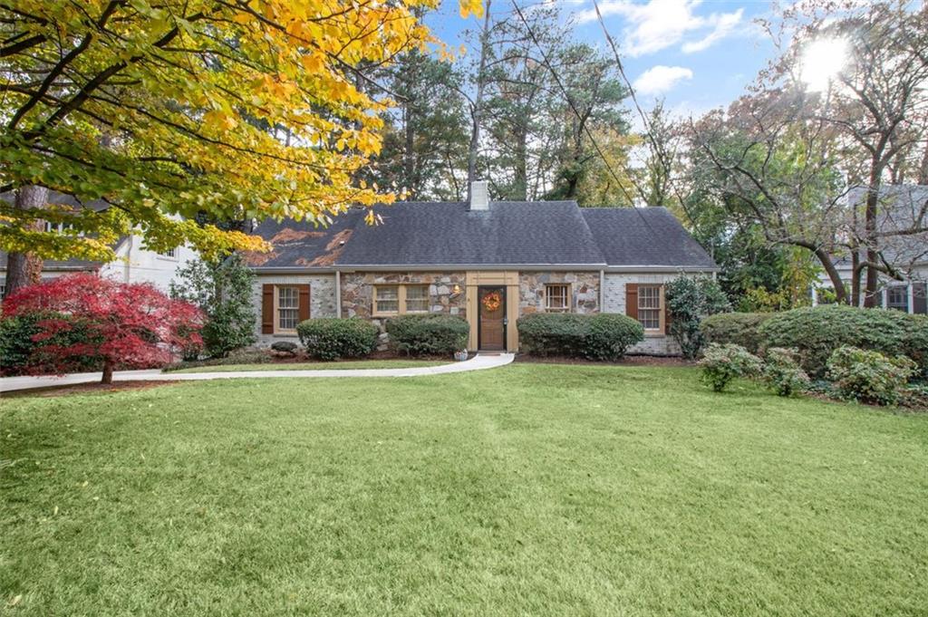 a front view of a house with a garden