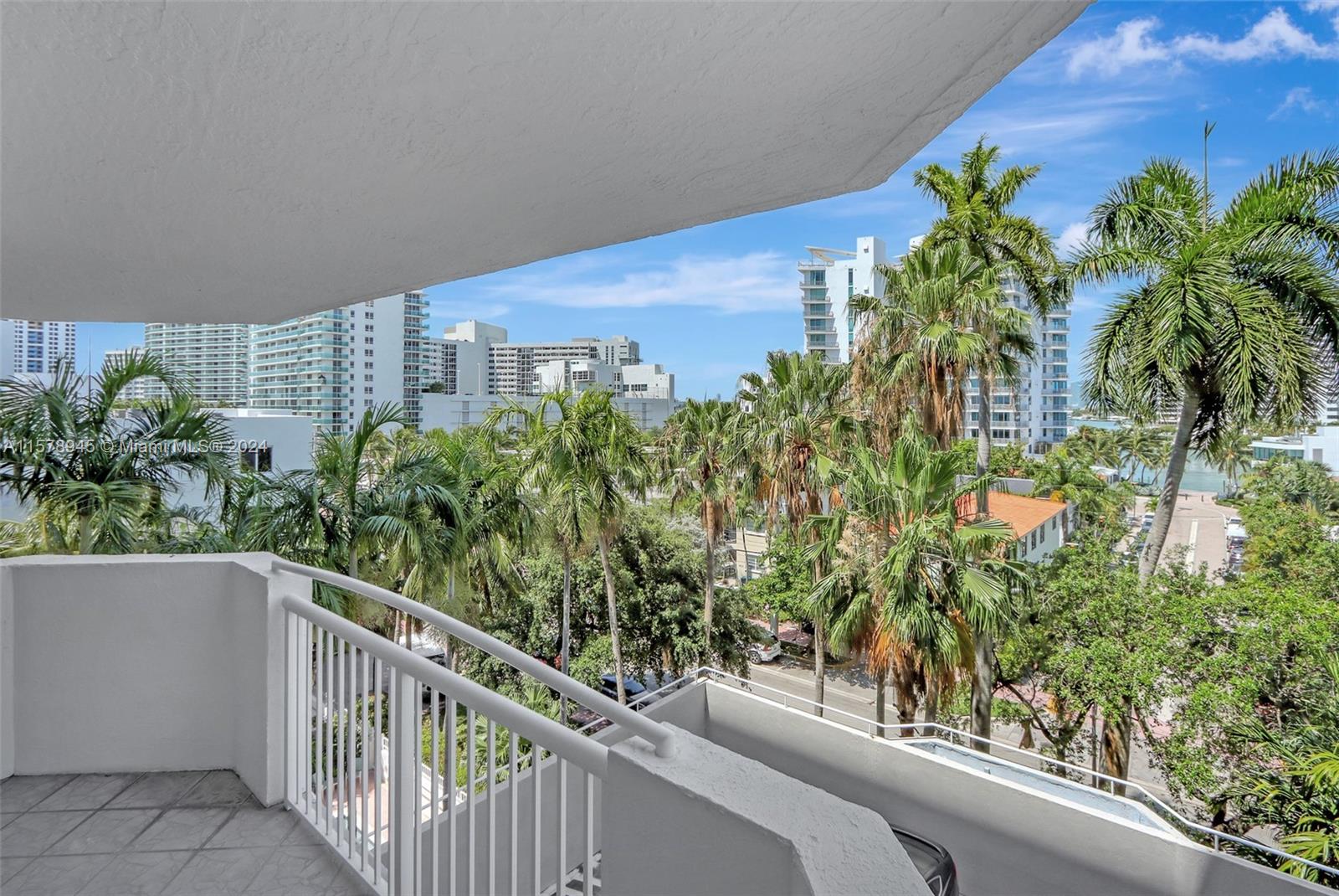 a view of a balcony and trees