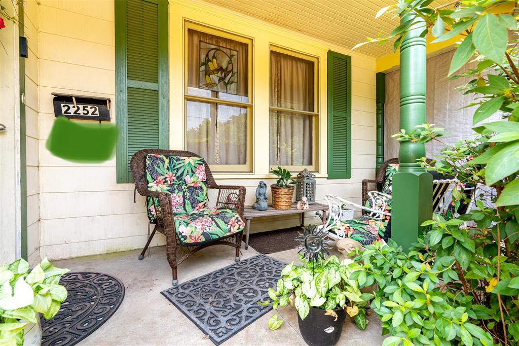 a living room filled with furniture and a potted plant