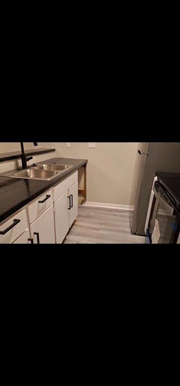 a view of kitchen island with sink