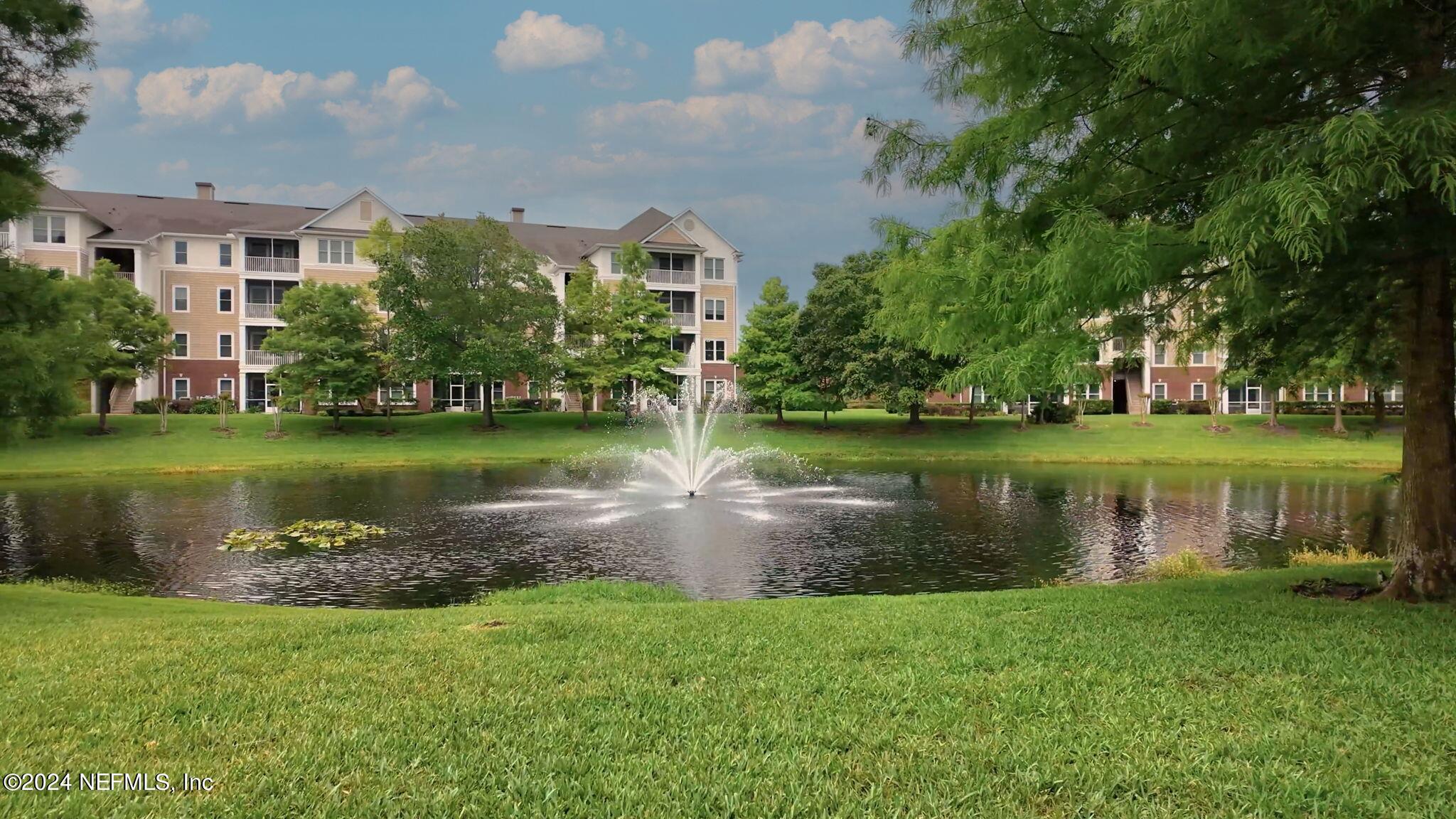 a view of a lake with a house in the background