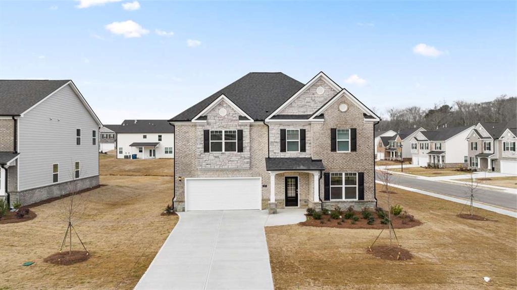 a front view of a house with a yard