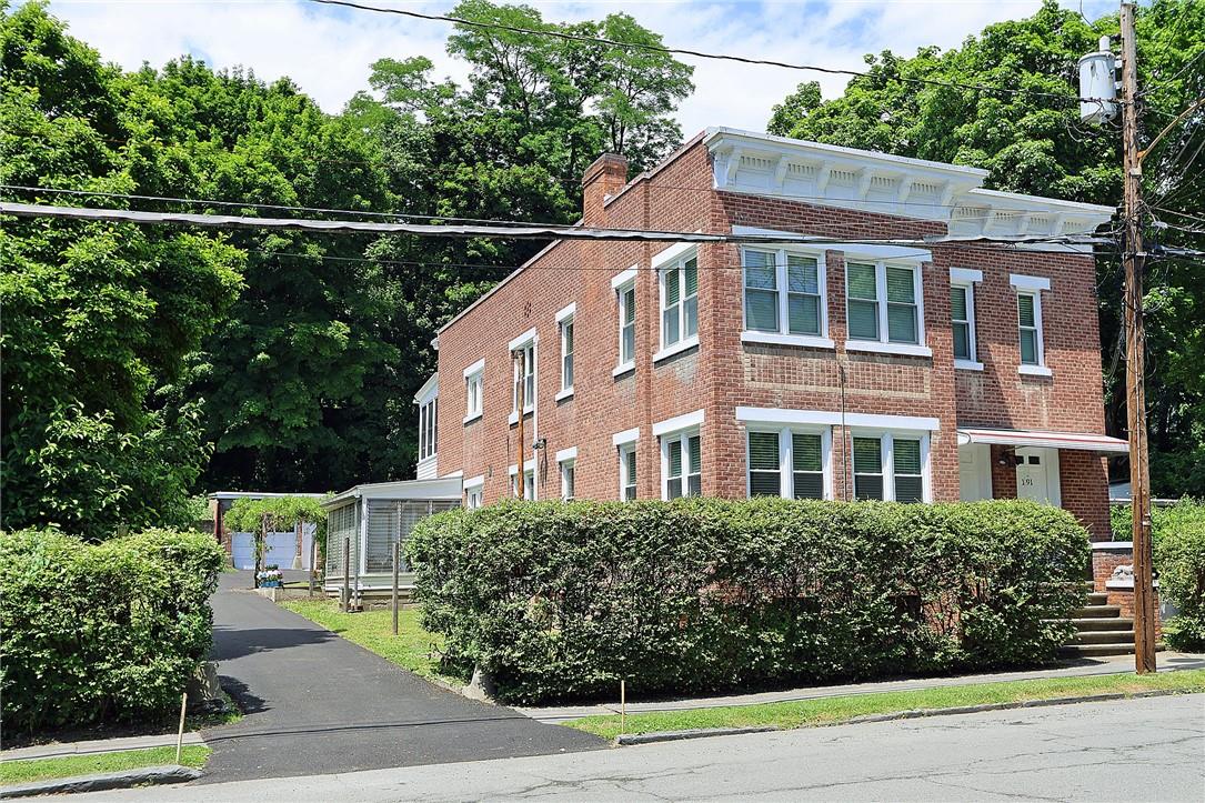 View of front of house with driveway to studio/workshop