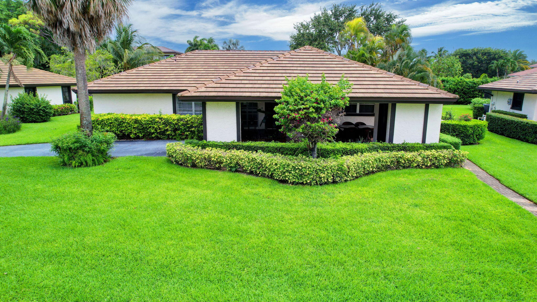 a front view of a house with a garden