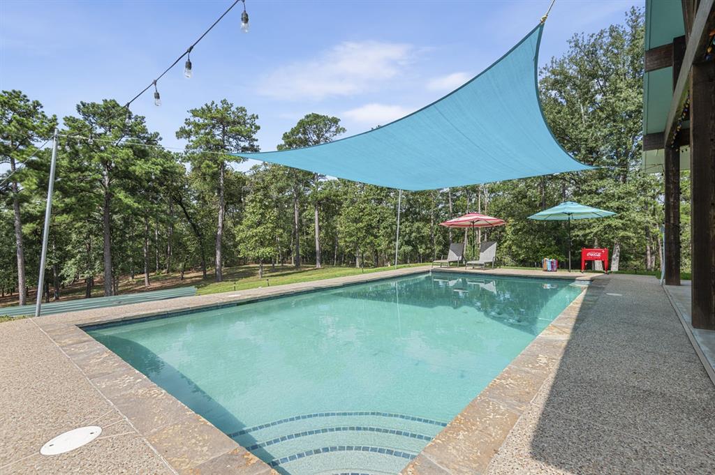 swimming pool view with a seating space