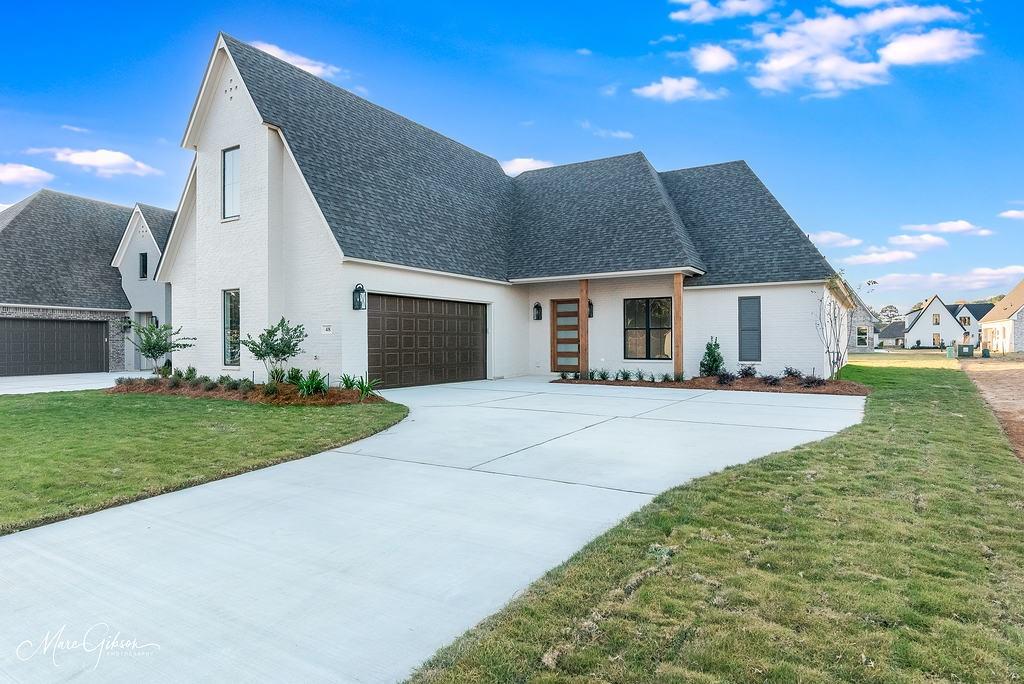 a front view of house with yard and green space