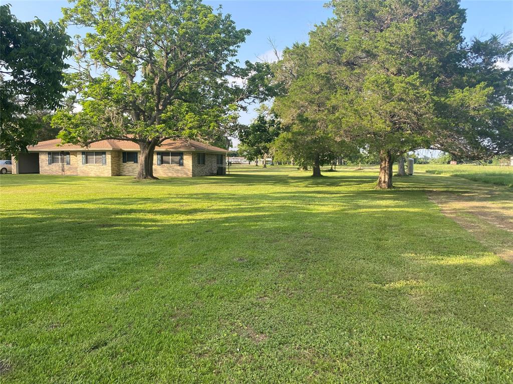 a front view of a house with a big yard