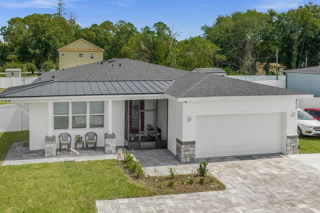 a view of house with yard and outdoor seating