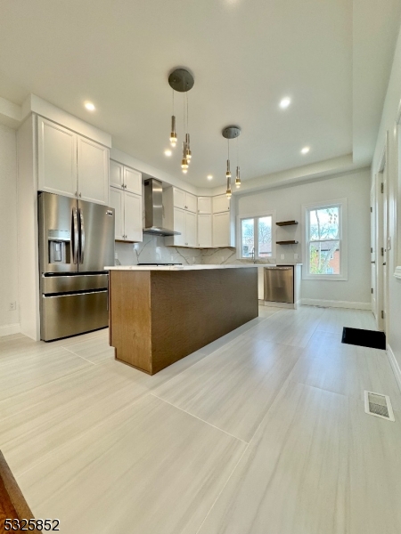 a large kitchen with stainless steel appliances lots of counter space and a sink