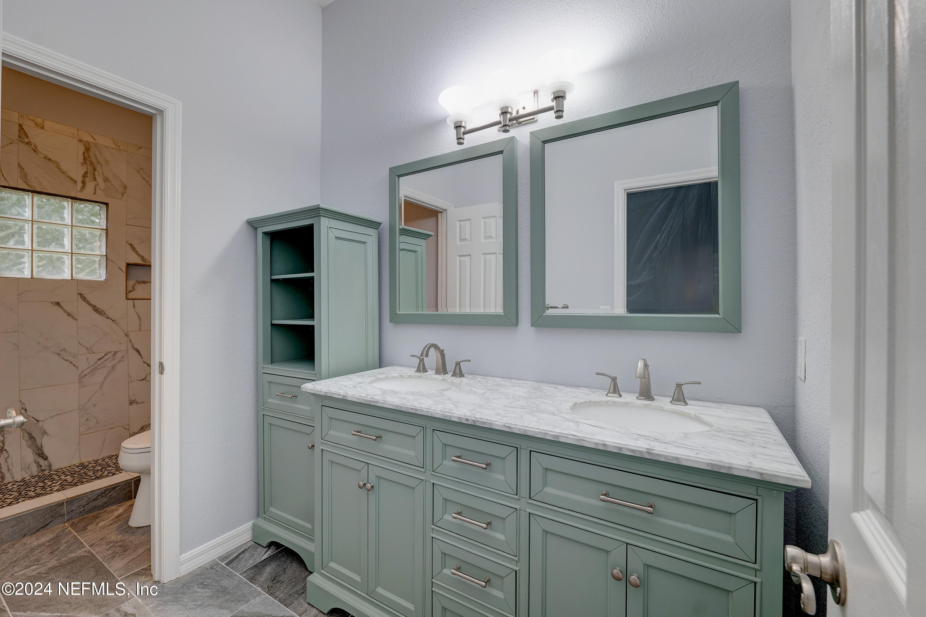 a bathroom with a double vanity sink and a mirror