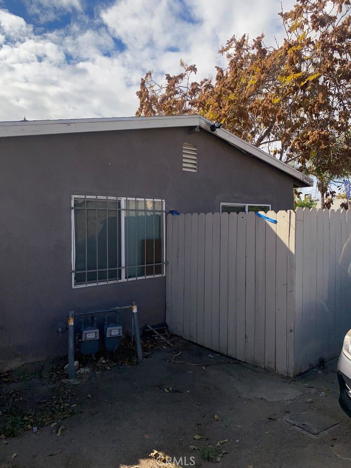 a backyard of a house with wooden fence