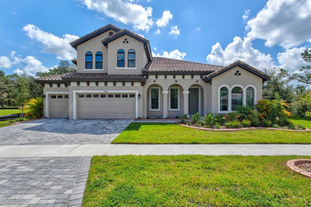 a front view of a house with a yard and garage