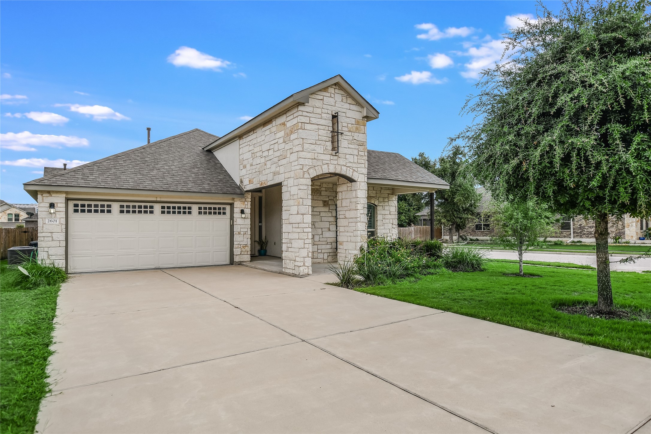 a front view of a house with a yard and garage