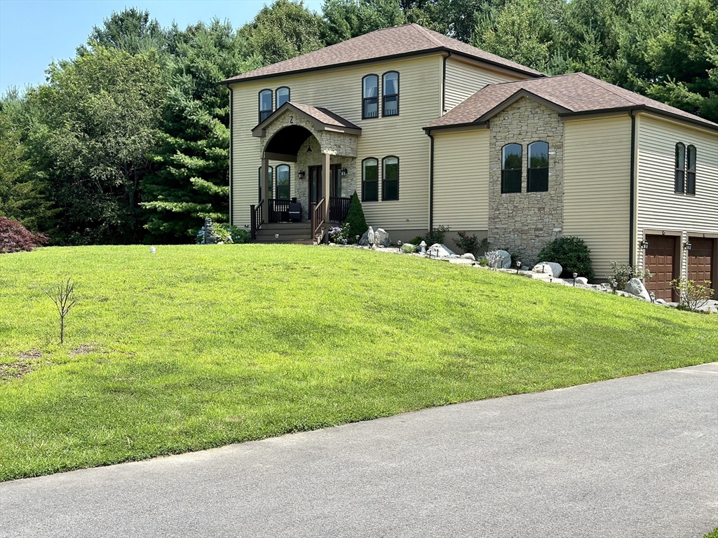 a front view of house with yard and green space