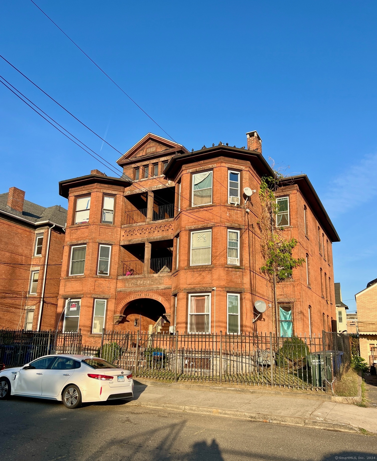 a front view of a residential apartment building with a yard