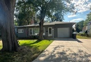 a view of a house with a yard and large tree