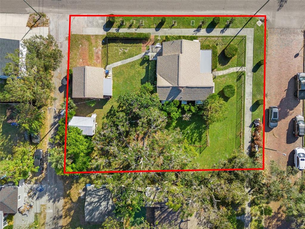 an aerial view of a house with a yard and fountain in front of it