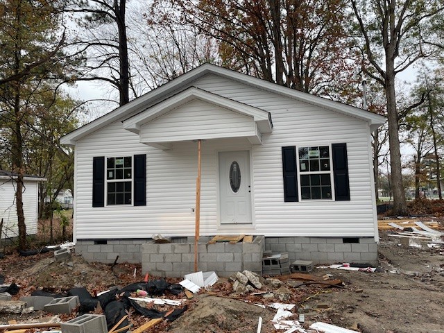 a front view of a house with sitting area