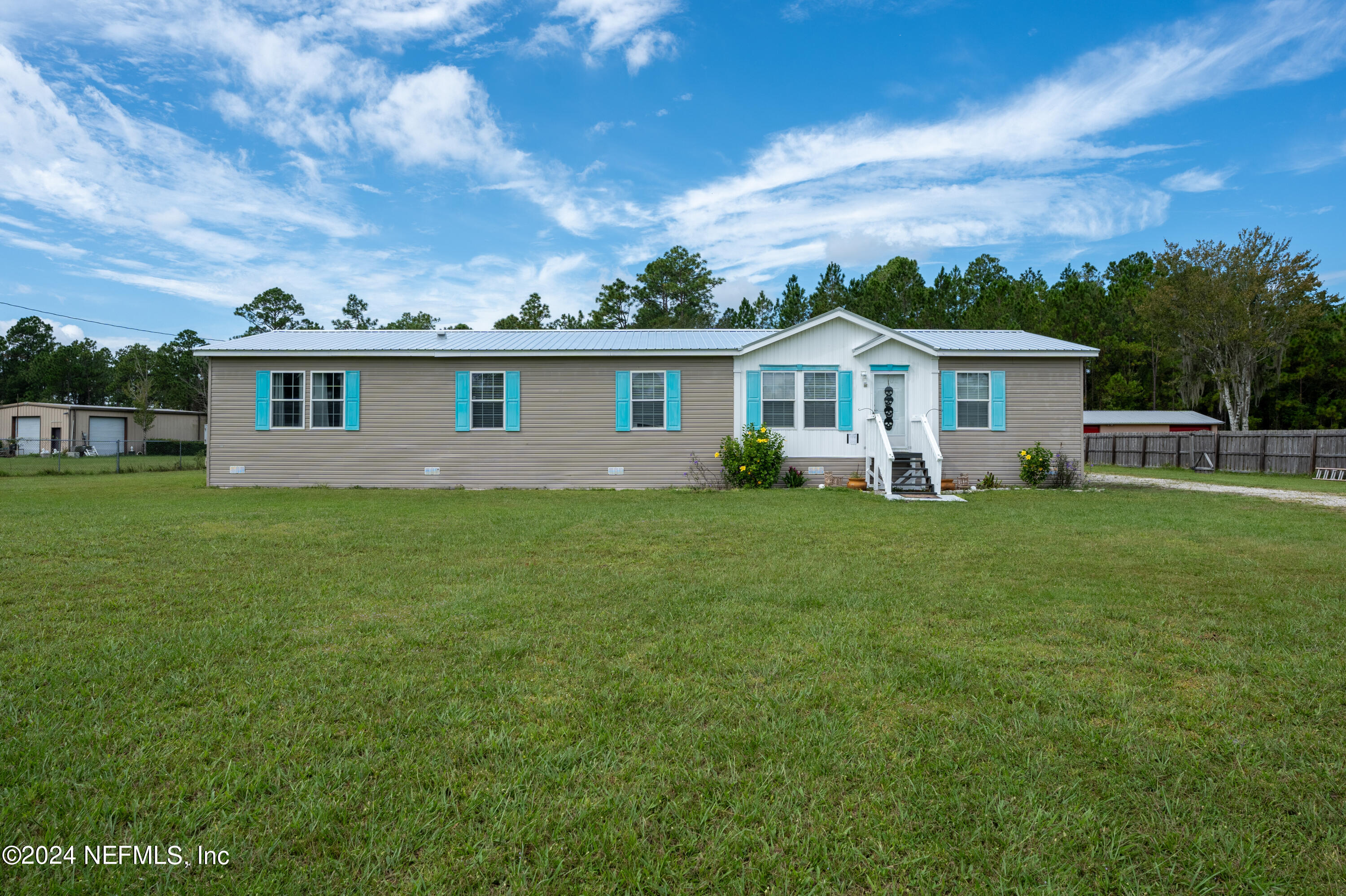 a front view of house with yard and green space