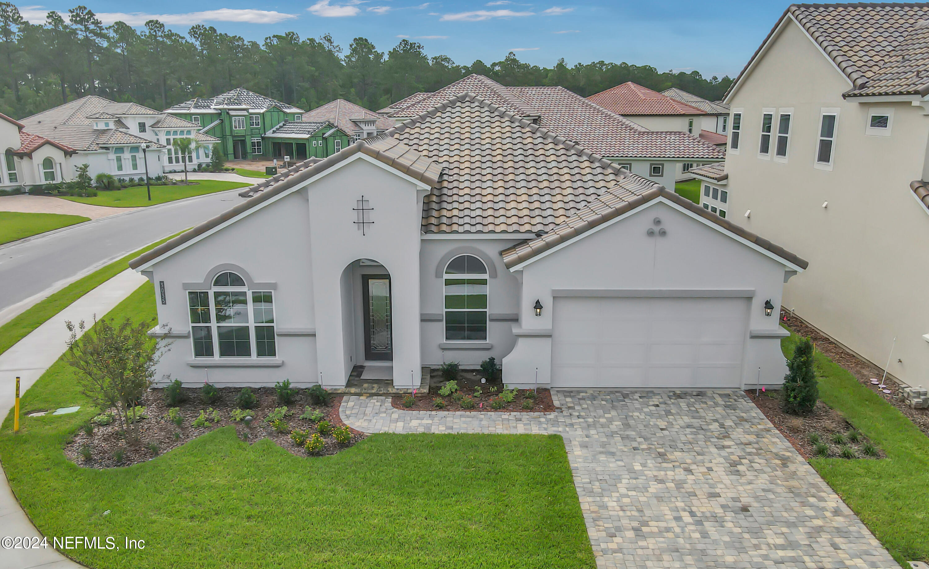 a front view of house with yard and green space