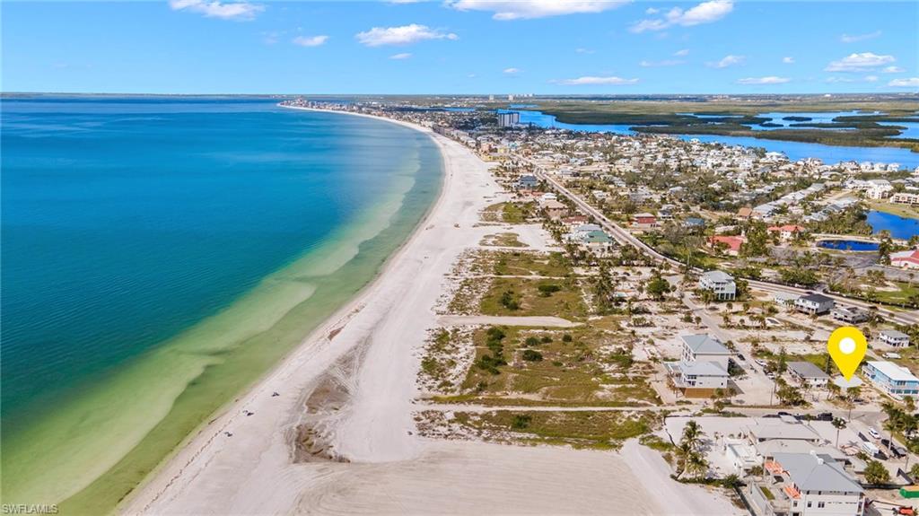 Aerial view featuring a beach view and a water view