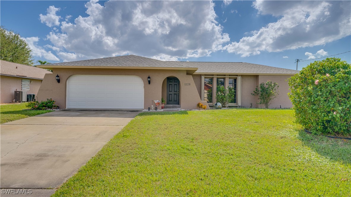 a front view of a house with yard and garage