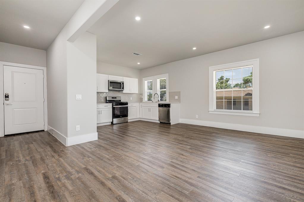 a view of kitchen with cabinets and wooden floor