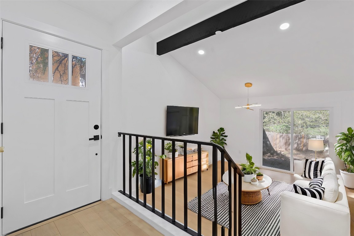 a view of entryway and hall with wooden floor