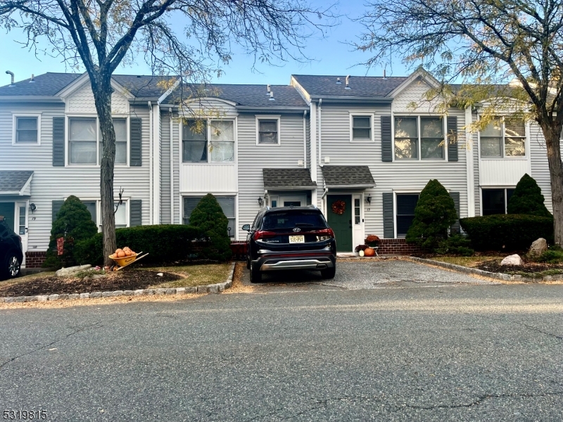 a car parked in front of a brick house