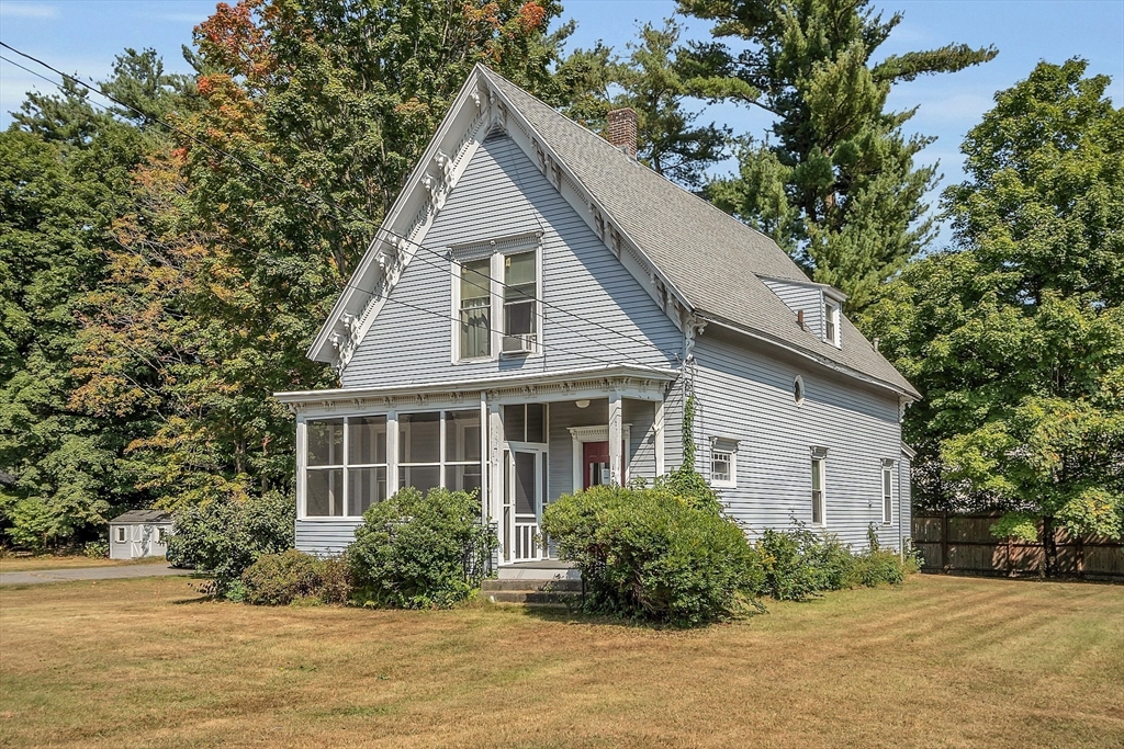 a view of backyard of house and garage