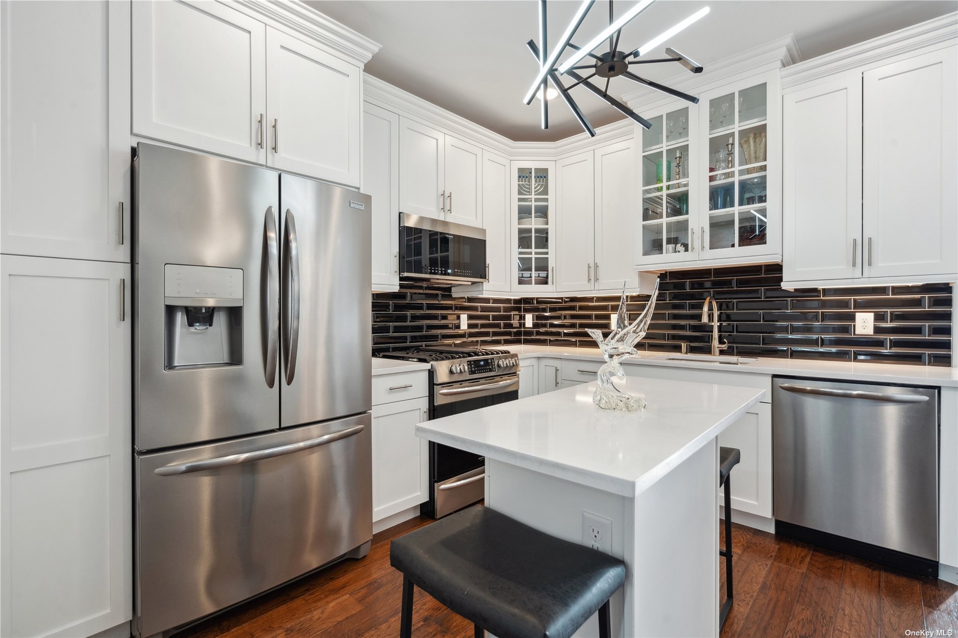 a kitchen with appliances a sink and cabinets