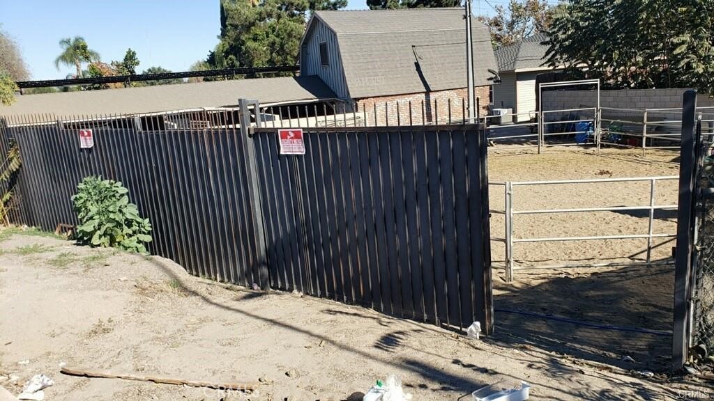 a view of a house with a wooden fence