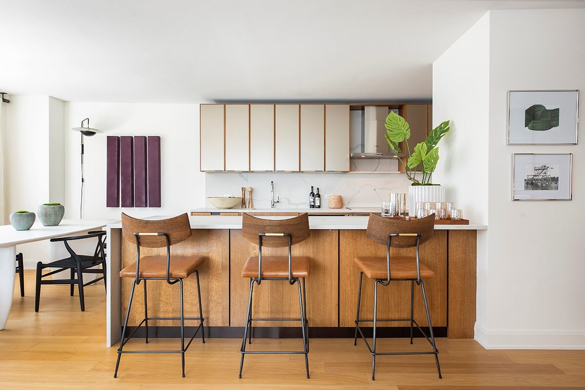 a kitchen with stainless steel appliances kitchen island granite countertop a table and chairs in it