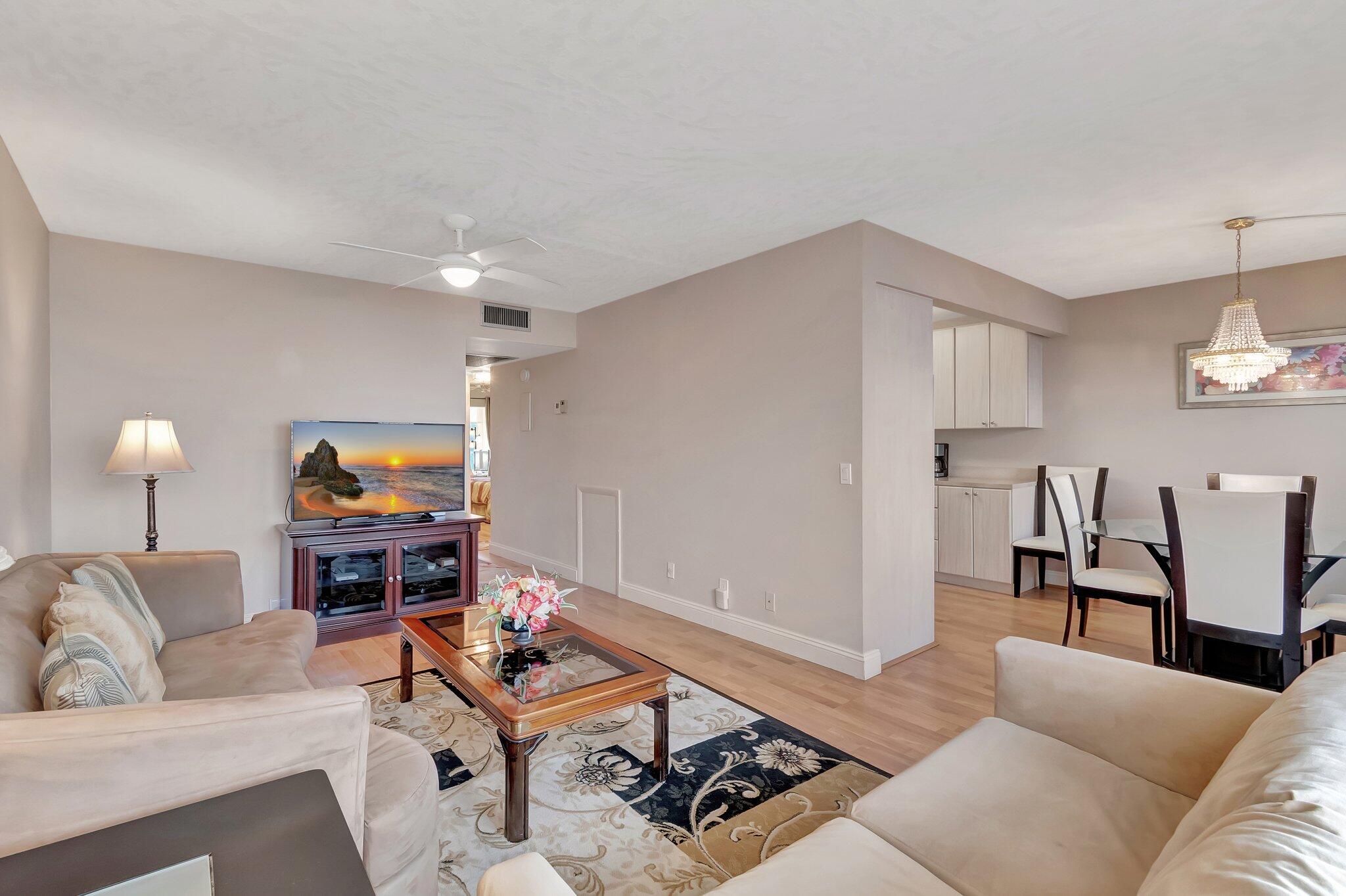 a living room with furniture a rug and a lamp