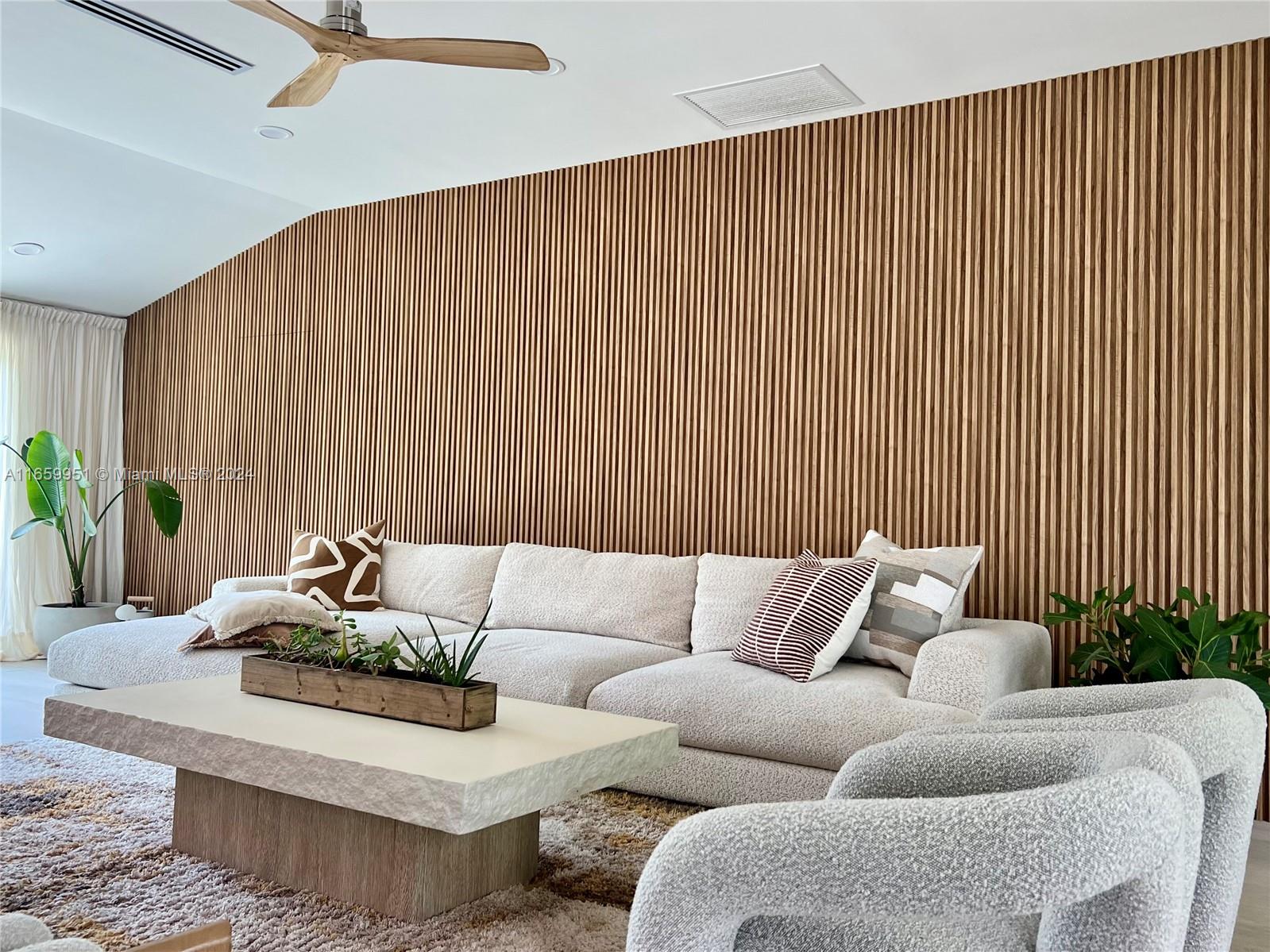 a living room with furniture and a potted plant