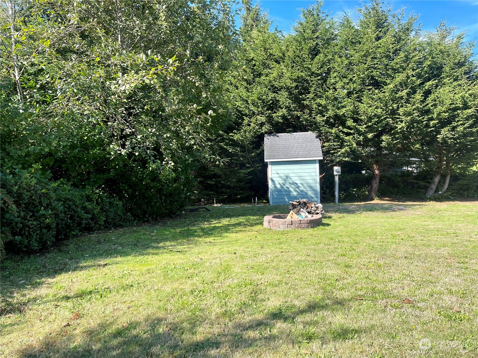 a view of a two chairs in the patio next to a yard