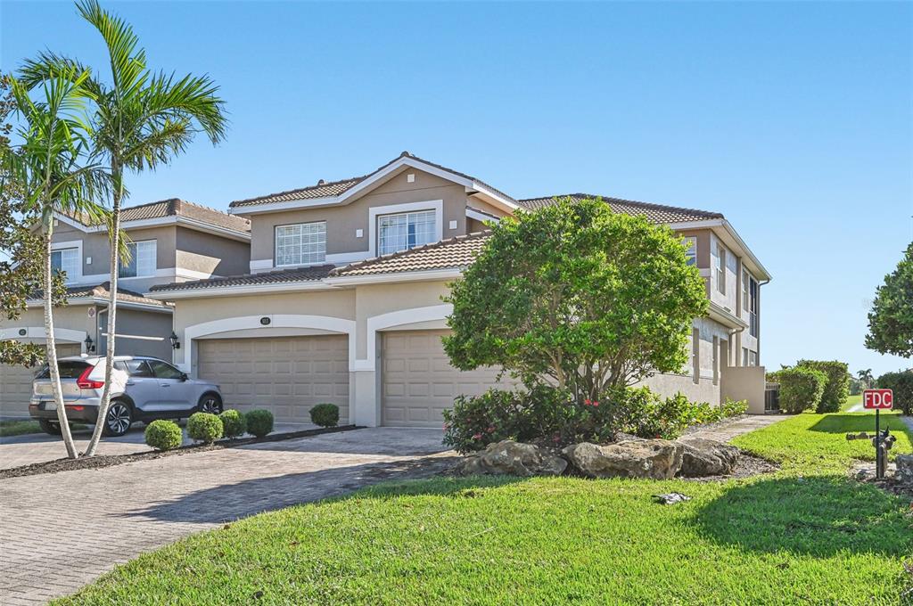 a front view of a house with a yard and garage