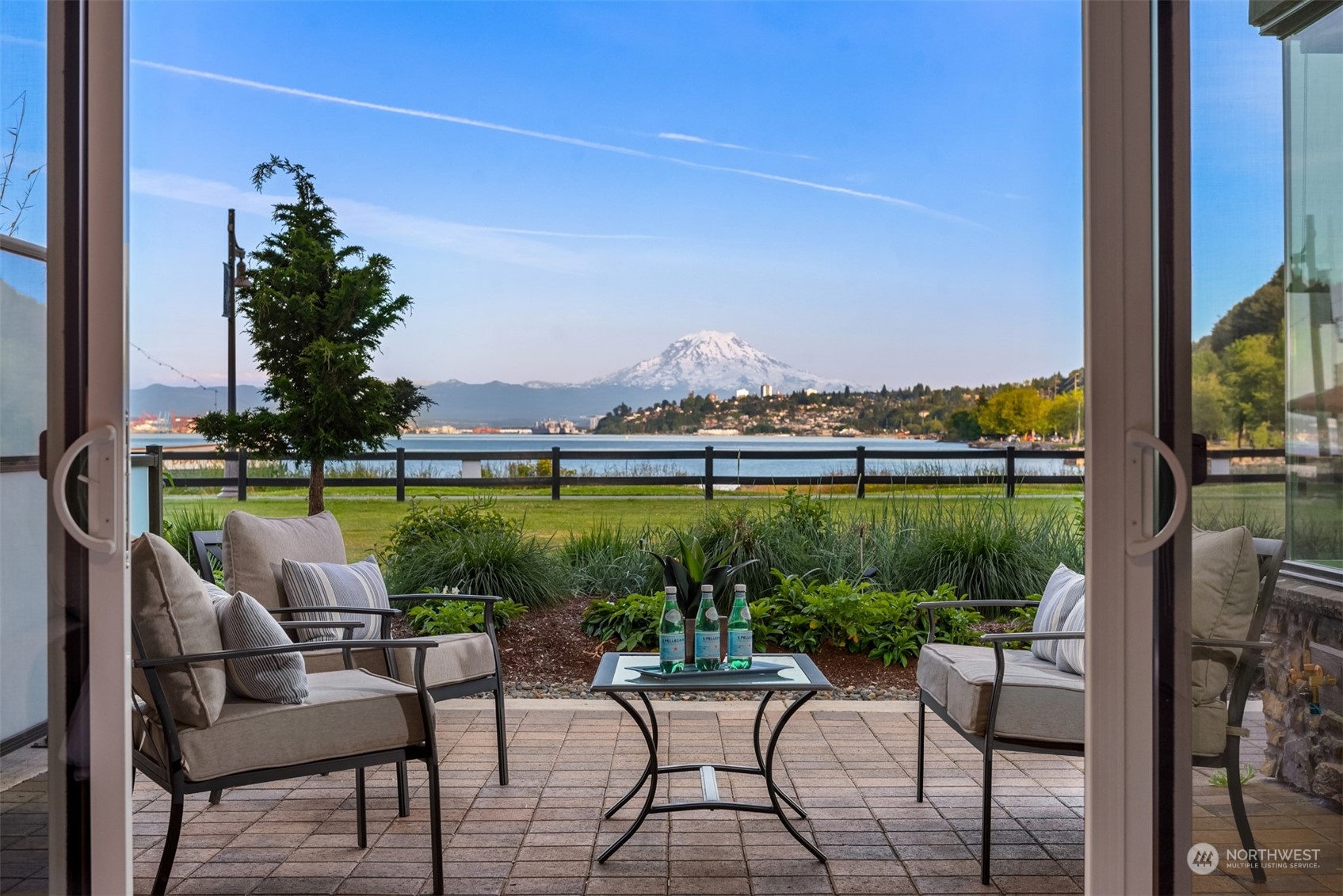 a view of a chairs and table in patio with a lake view