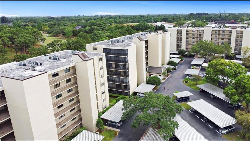 an aerial view of a residential apartment building with a yard