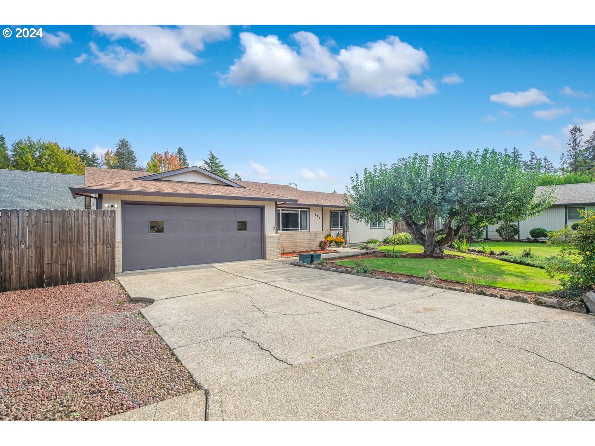 a view of a house with a backyard and a garage