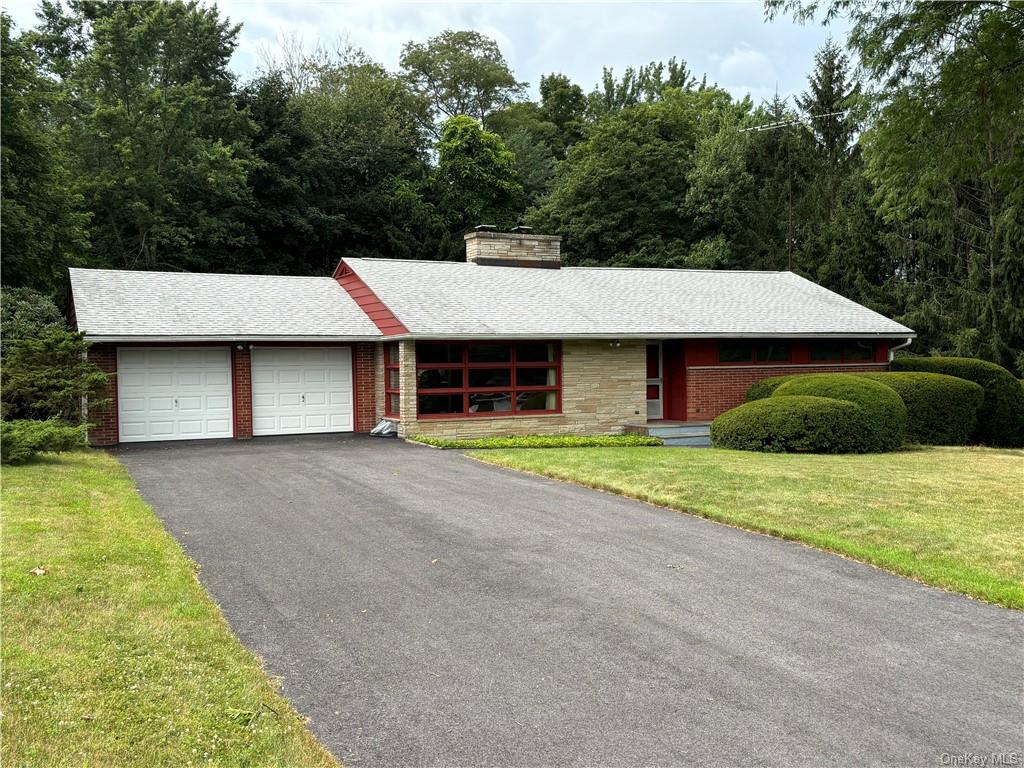 a aerial view of a house with a yard and garage